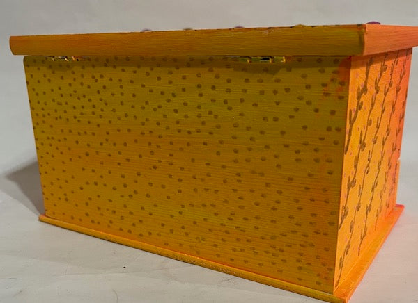 A jewelry box with golden dotted back