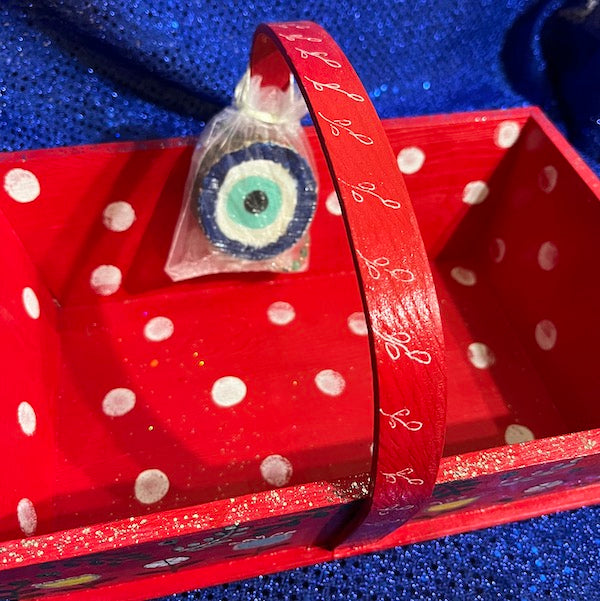 A red hand painted wooden basket