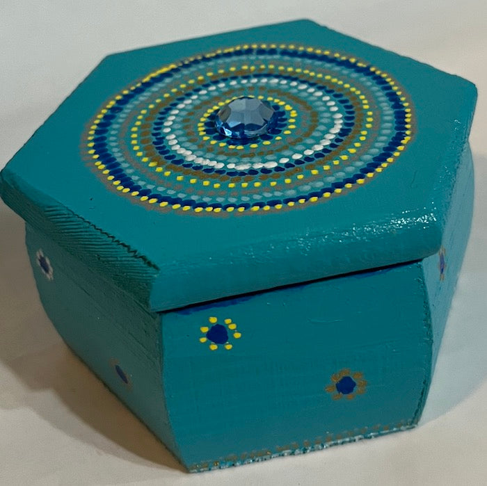 A blue hand painted jewel top hexagon wooden box box