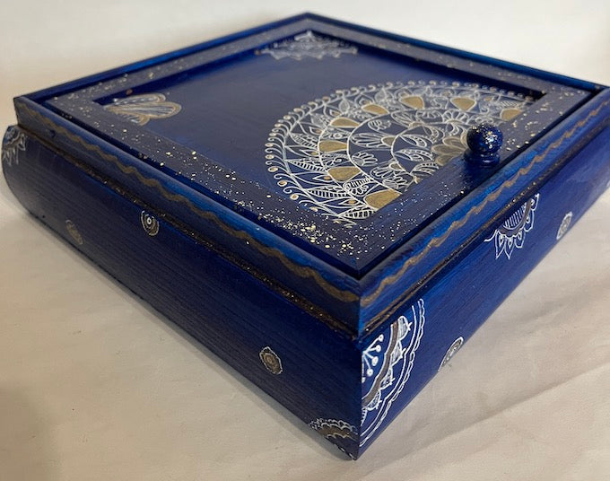 A wooden hand painted blue jewelry box