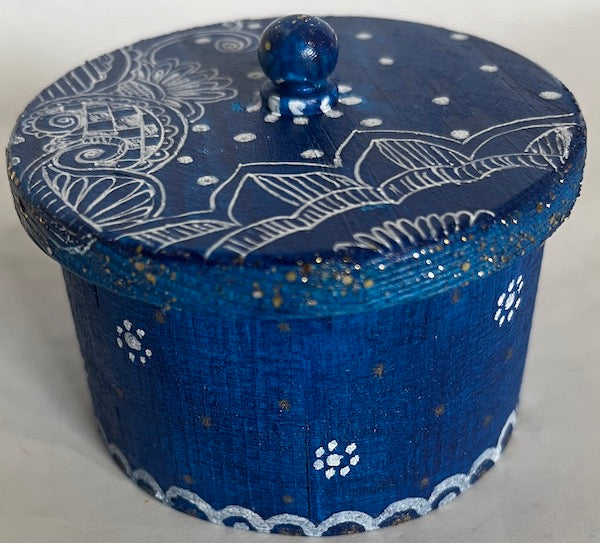 A hand painted blue round box with lid