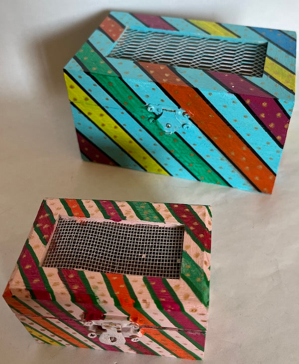 A pink hand painted colorful striped mini gift box.