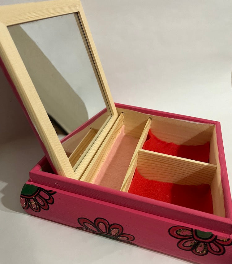 A  wooden hand painted pink jewelry box