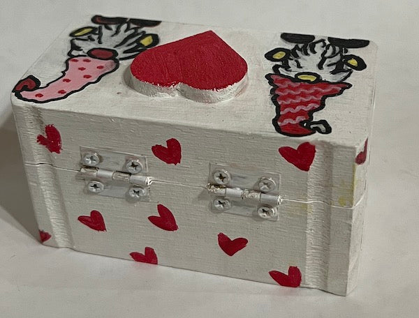 A hand painted white gift box with hearts and a heart top