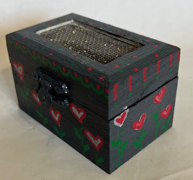 A hand painted gray wooden box with hearts