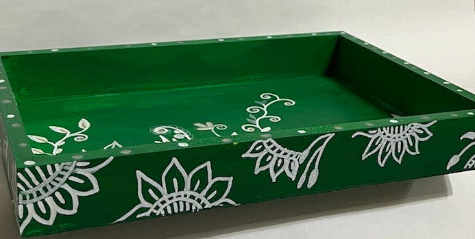 A hand painted green and white tray