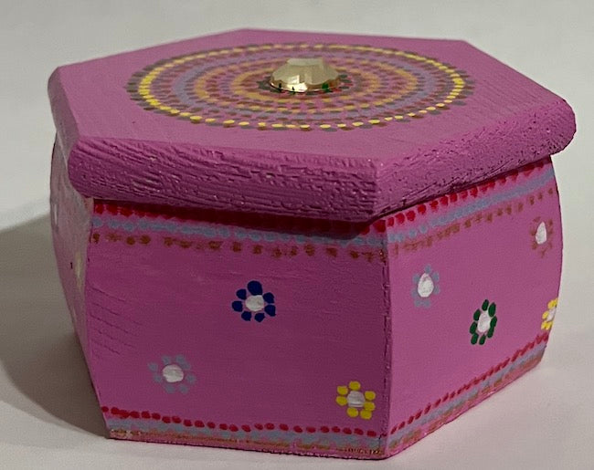 a jewel top hexagon shaped pink box with dot art