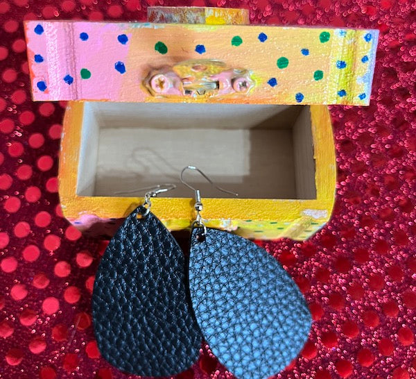 A leather earring with small hand painted wooden box