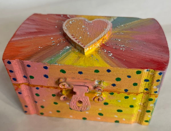 A small wooden heart top box