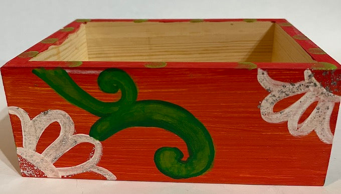 An orange hand painted wooden box with a removable lid