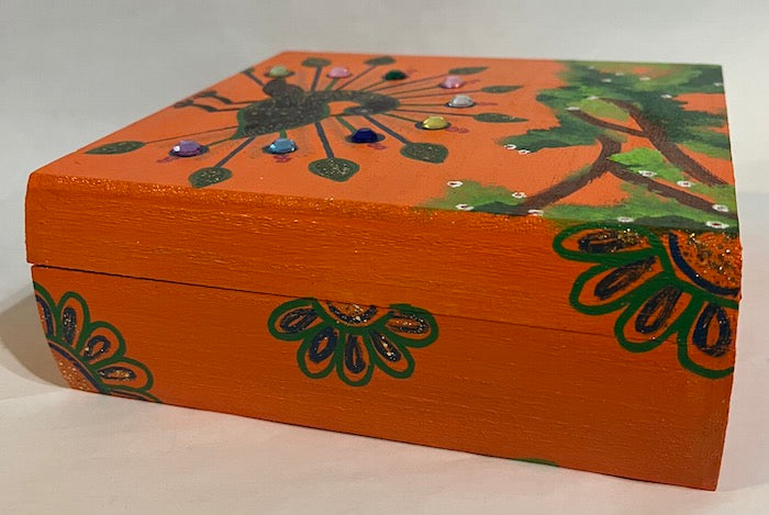 A hand painted orange wooden box