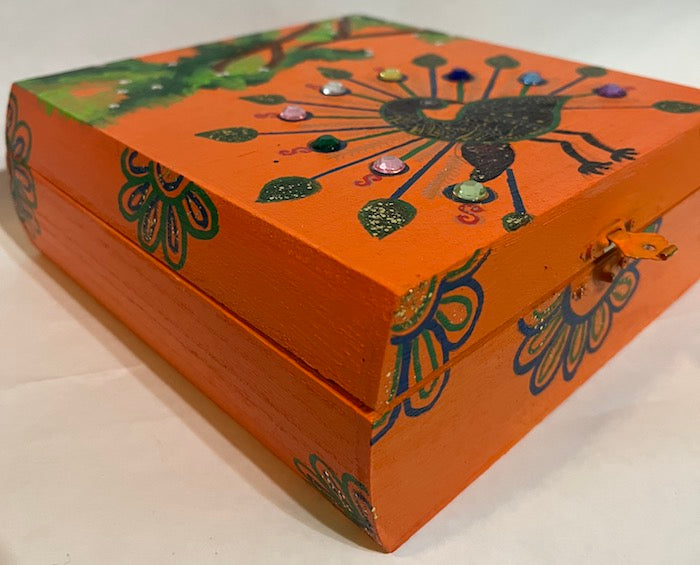 A hand painted orange jewelry box