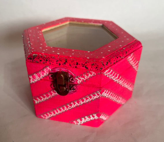 A bright pink jewelry box