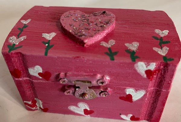 A pink heart wooden box with lid