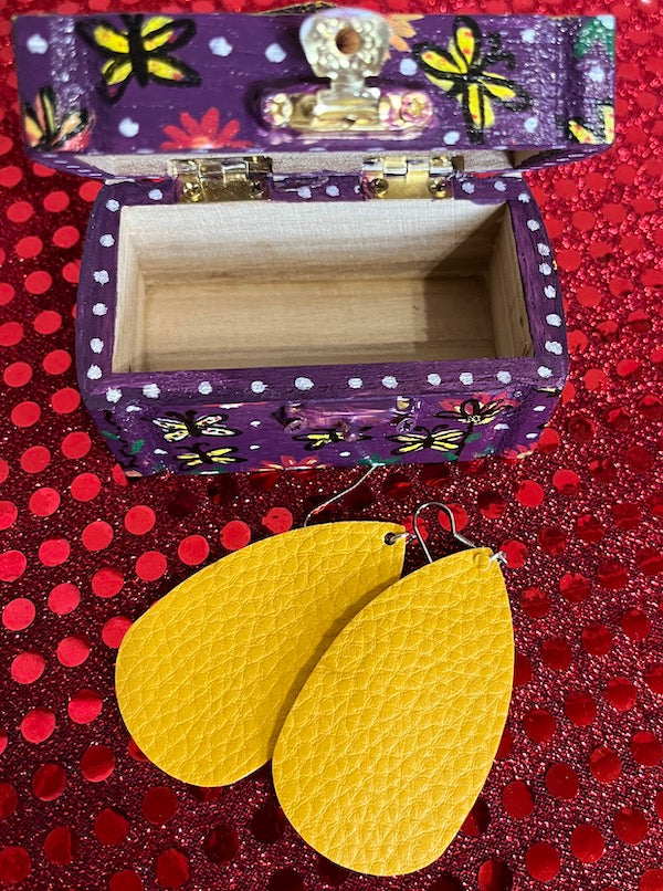 A small hand painted box with leather earrings