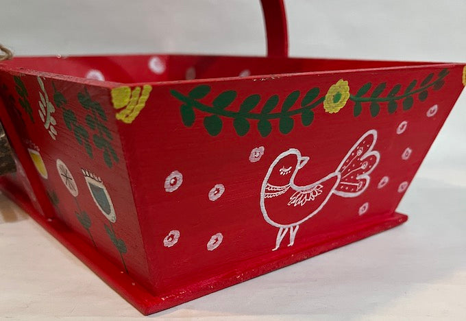 A hand painted Peacock art on a red basket