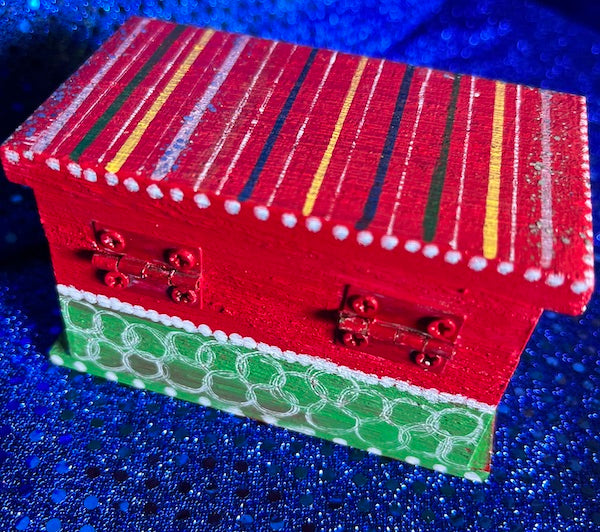 A hand painted red wooden box