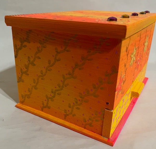 Side view of an orange hand painted jewelry box