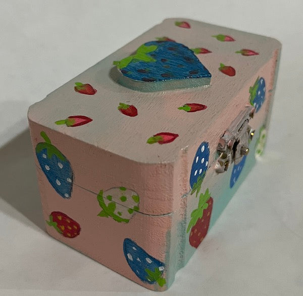 A hand painted pink and blue wooden box