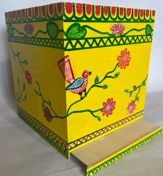 A bright yellow tissue box cover